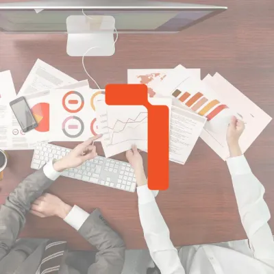 Hands over business analytics and charts on a desk