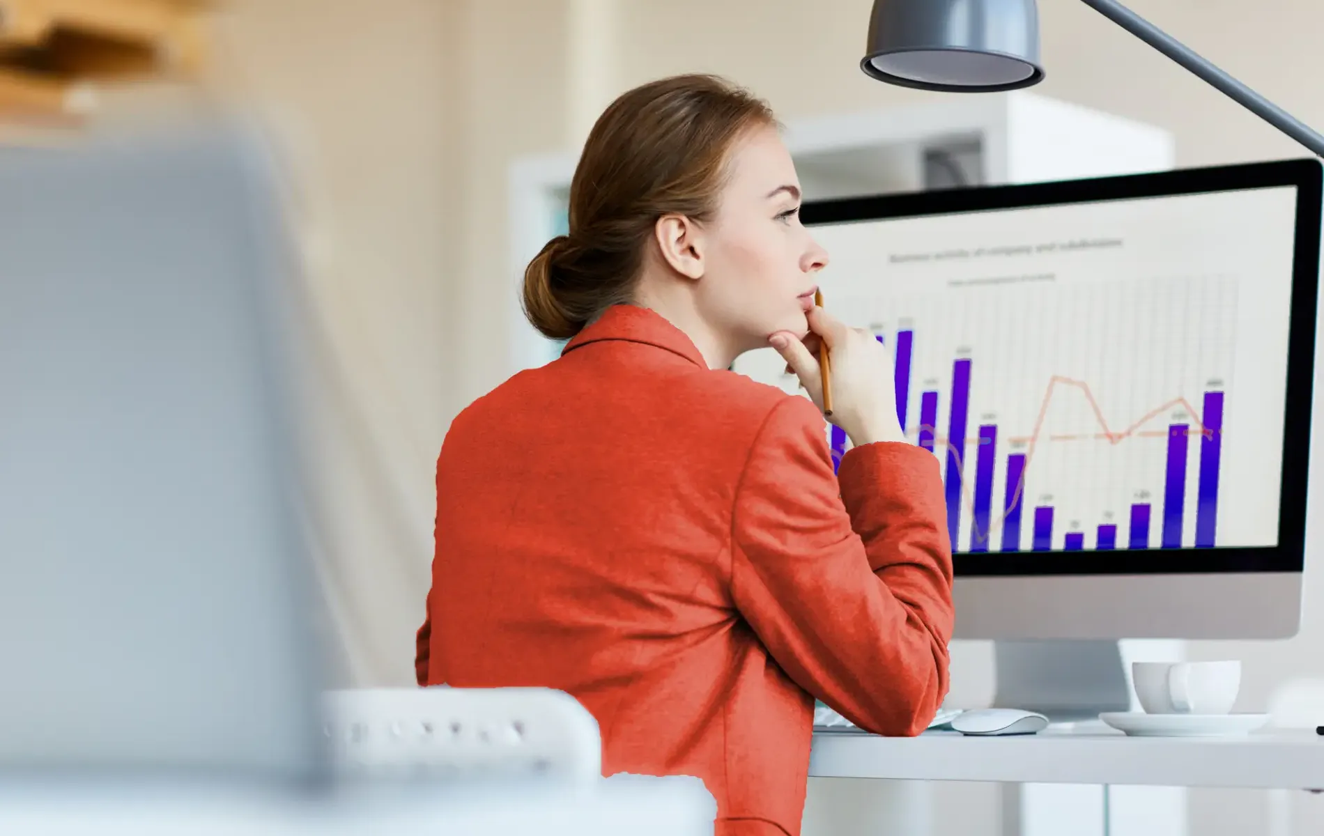 Woman analyzing data charts for predictive analysis on computer dashboard