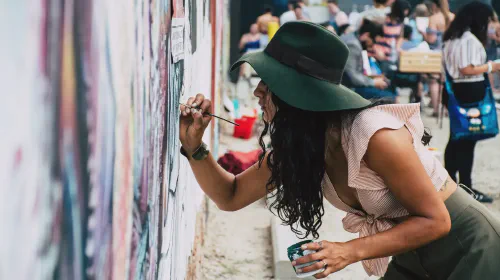 Photo of Woman Painting on Wall