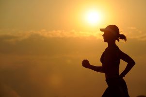 Woman jogging at sunrise