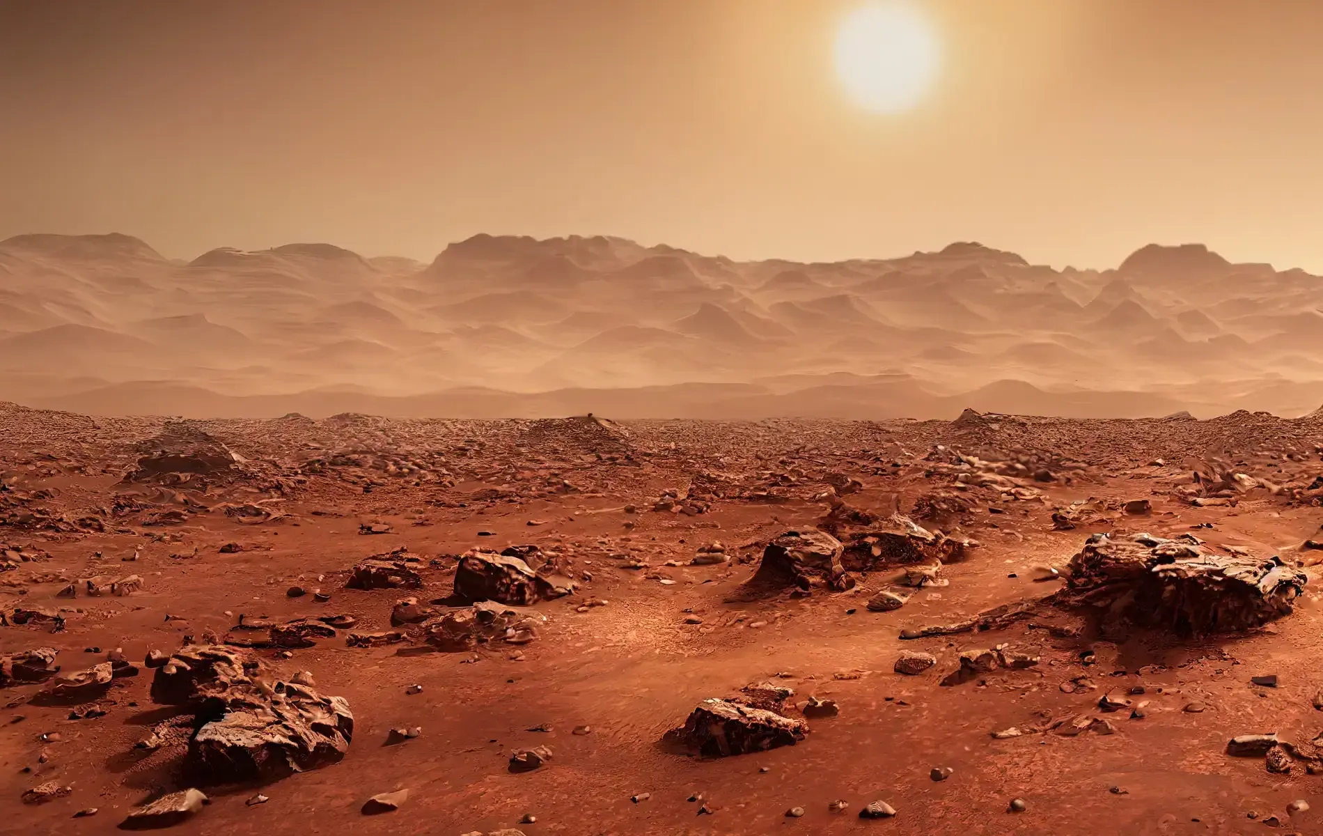 A rocky, red Martian landscape with mountains under a hazy sun.