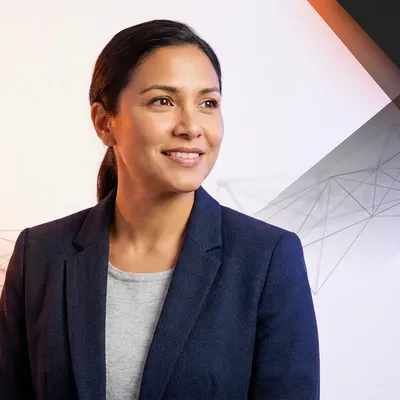 Smiling businesswoman in a navy blazer looking away against a modern geometric background.