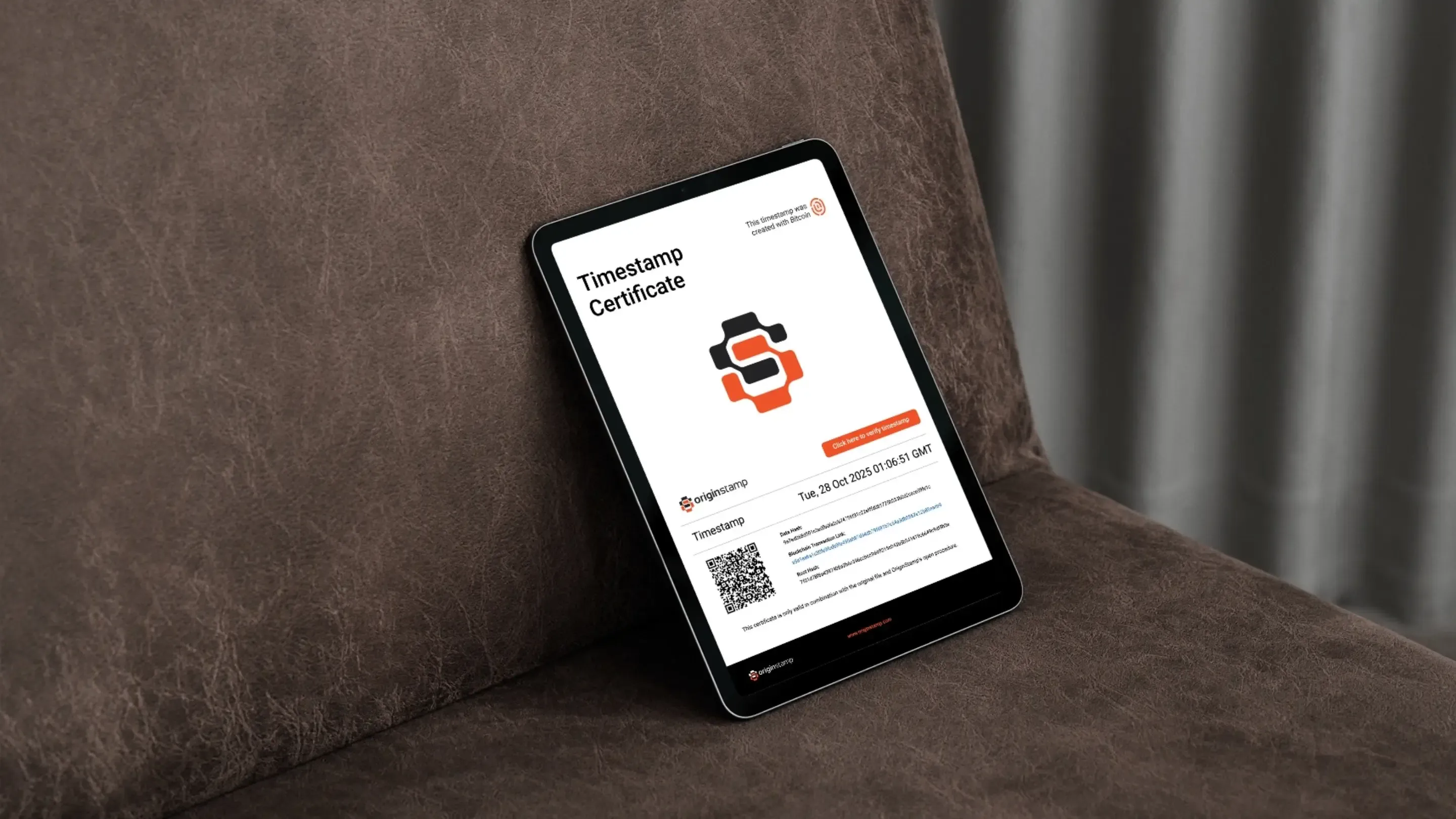 A tablet displaying a timestamp certificate, leaning against a brown couch.