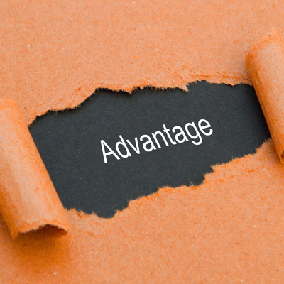 Torn orange paper reveals the black word “Advantage.”